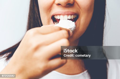 istock Close-up Women Biting Cookie 872125582