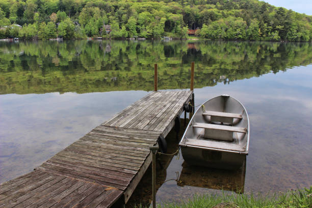 istock Row Boat on a dock at the lake 872127962