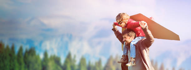istock Little Boy Flying in a Cardboard Plane 872128436
