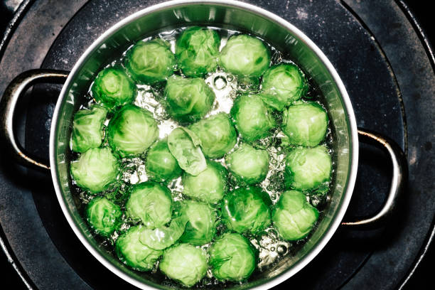 Brussels sprouts in a pan of boiling water.