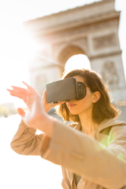 istock tourist woman using a virtual reality device in paris 872132412
