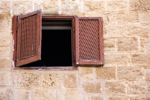 istock ancient window with shutters in a stone house 872135114