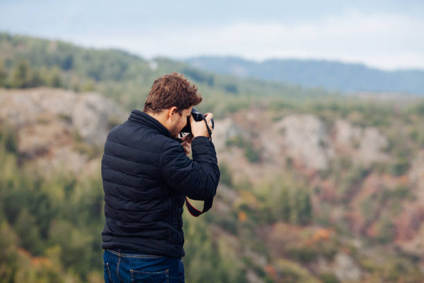 istock Man taking photo in nature 872135410