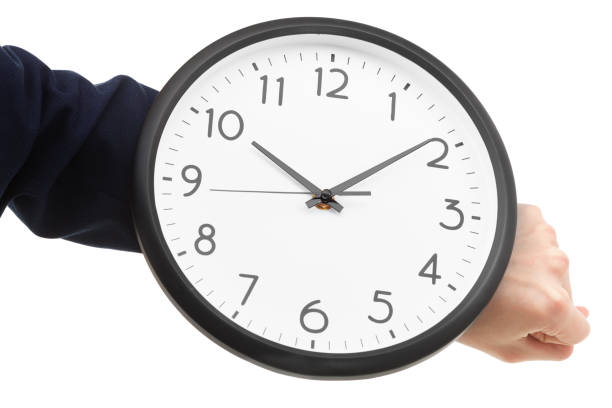 istock Businessman hand holding wall clock, time management 872138574
