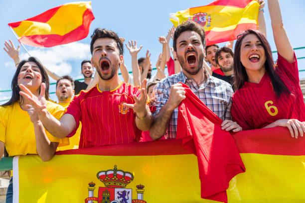 istock Spanish supporters cheering at stadium with flags 872146586