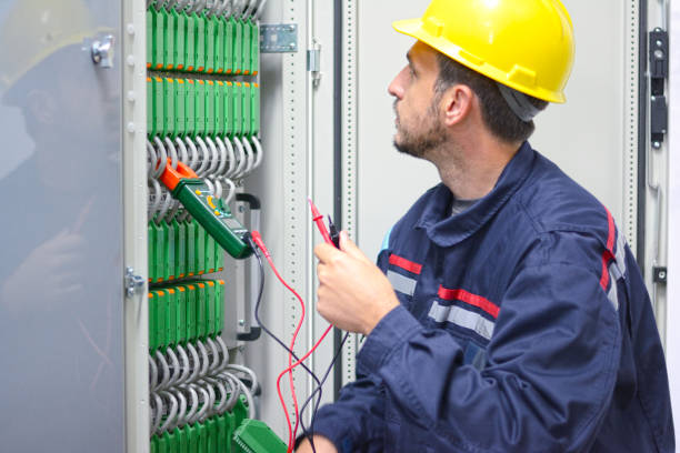 istock Electrician working on a circuit board in electric room. 872147236