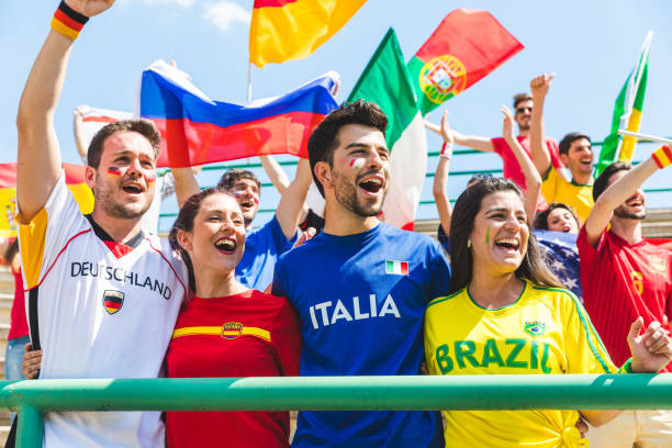 istock Happy fans supporters from different countries together at stadium 872147490