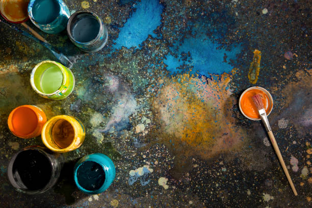 istock Paints by the time drawing cans and brushes on a paint-sprayed palette 872150818