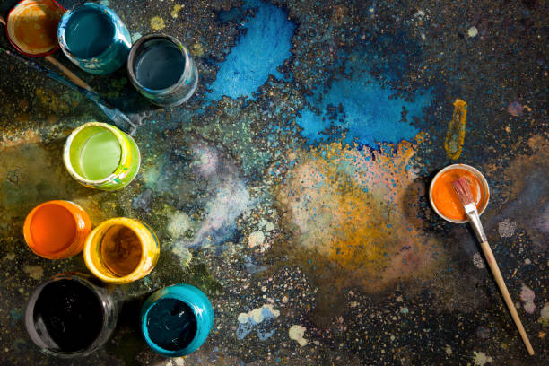 istock Paints by the time drawing cans and brushes on a paint-sprayed palette 872150820