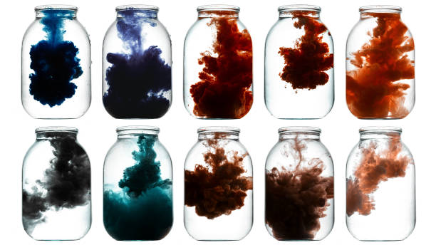 istock Luminous paint swirling in water. 872155744