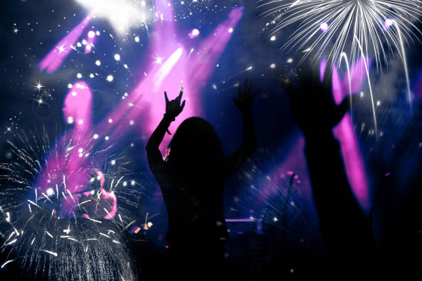 istock new Year concept - cheering crowd and fireworks 872163832
