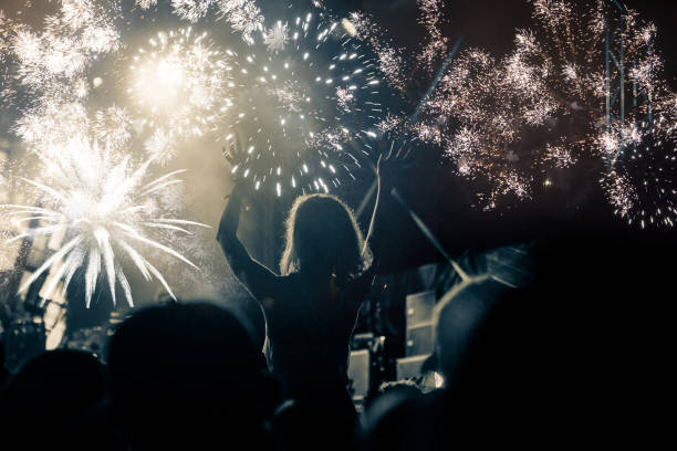 istock new Year concept - cheering crowd and fireworks 872163844