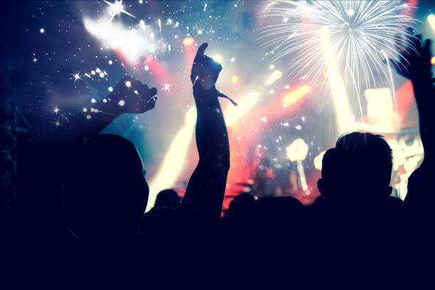 istock new Year concept - cheering crowd and fireworks 872163868