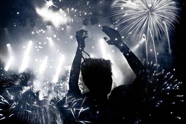 istock new Year concept - cheering crowd and fireworks 872163894