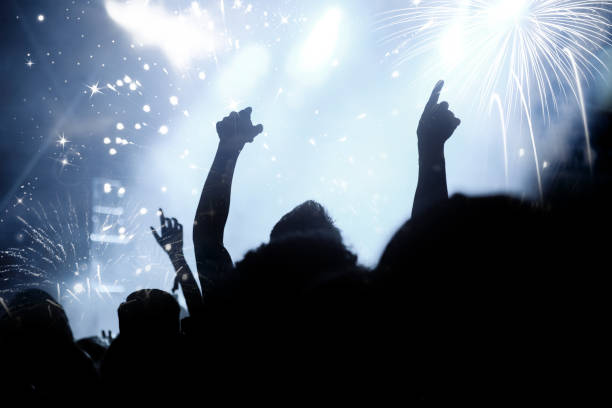 istock new Year concept - cheering crowd and fireworks 872163962