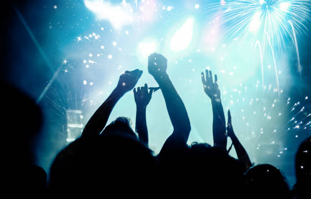 istock new Year concept - cheering crowd and fireworks 872163978