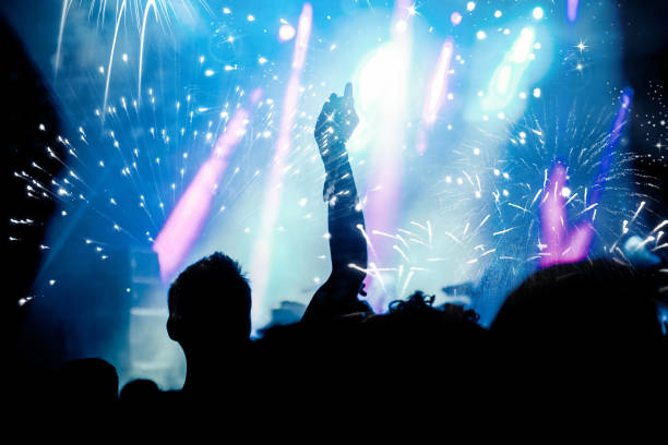 istock new Year concept - cheering crowd and fireworks 872163990