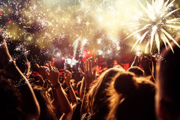 istock new Year concept - cheering crowd and fireworks 872164000