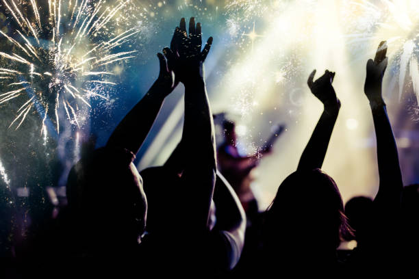 istock new Year concept - cheering crowd and fireworks 872164030