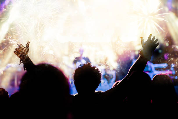 istock new Year concept - cheering crowd and fireworks 872164038