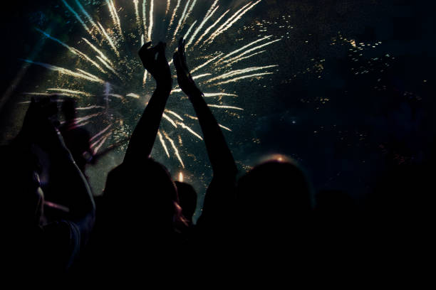 istock new Year concept - cheering crowd and fireworks 872164040