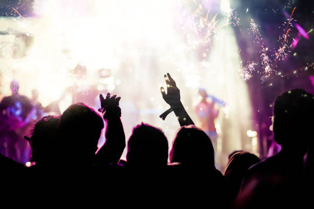 istock new Year concept - cheering crowd and fireworks 872164060