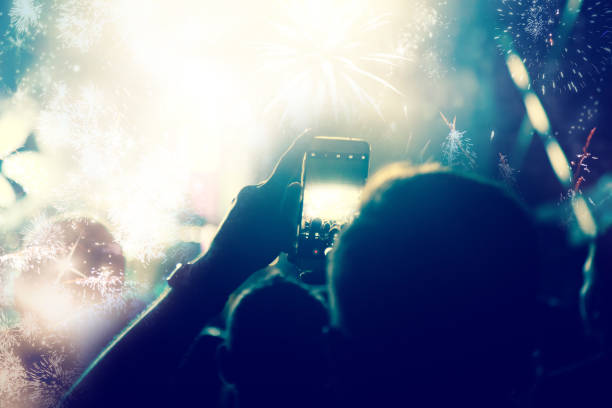 istock new Year concept - cheering crowd and fireworks 872164184
