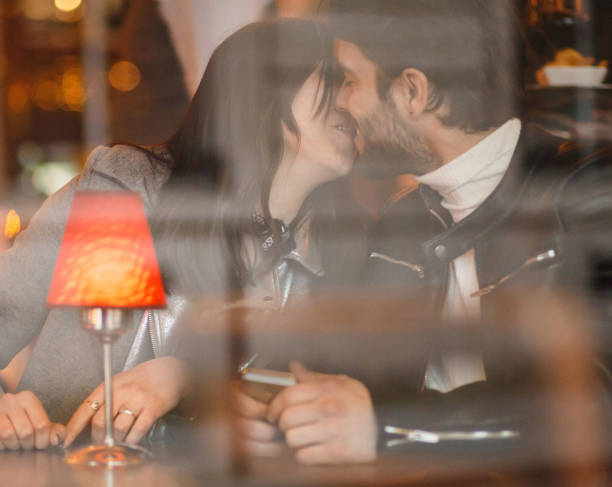 istock Couple kissing in a cafe 872178452