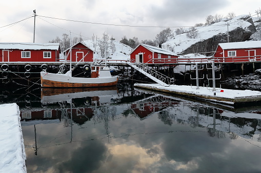 Snow covered harbor-Nusfjord fishing village-fishing boat moored in. Flakstadoya-Lofoten-Norway. 0492