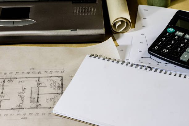 istock architect's table, laptop, calculator on the table. Plans, projects and notepad on the architect's table. 872183642