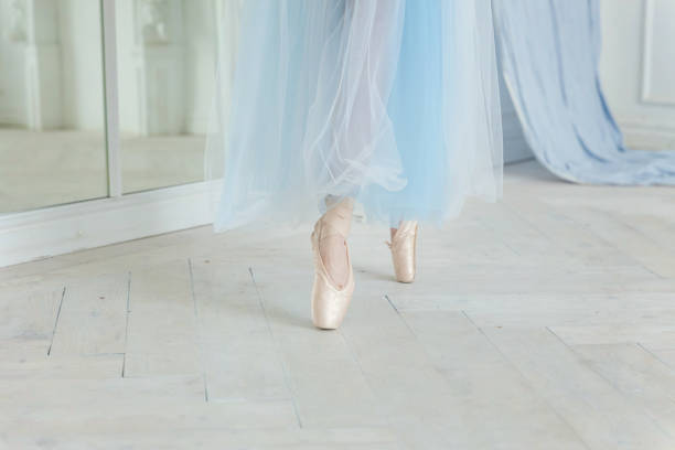 istock Ballerina puts pointe shoes 872188414