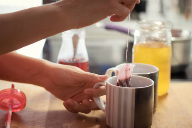 Close up of woman preparing tea in the kitchen.