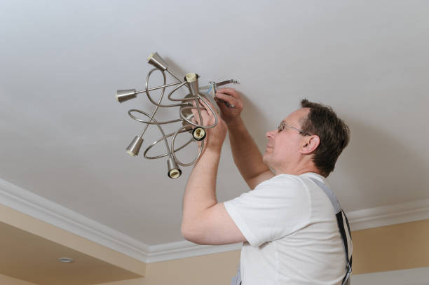 istock Electrician is installing and connecting a lamp. 872207904