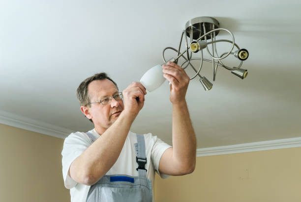 istock Electrician is installing and connecting a lamp. 872207922