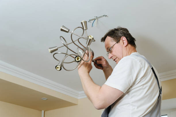 istock Electrician is installing and connecting a lamp. 872207988