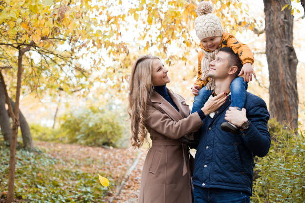 family to boys walk on autumn woods - couple walking old middle imagens e fotografias de stock