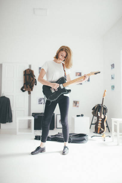istock Woman guitarist playing 872222684