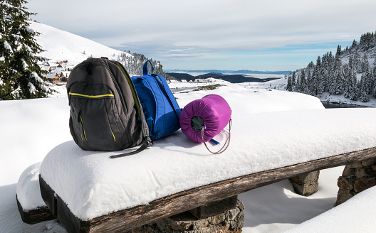 Two backpacks and sleeping bag on the snow.