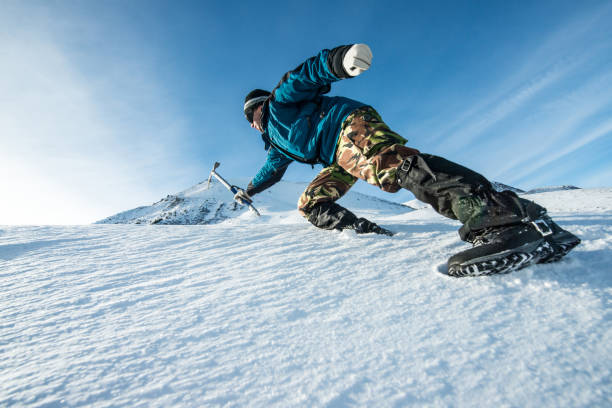istock climber with an ice ax climb on the snowy mountain 872226178
