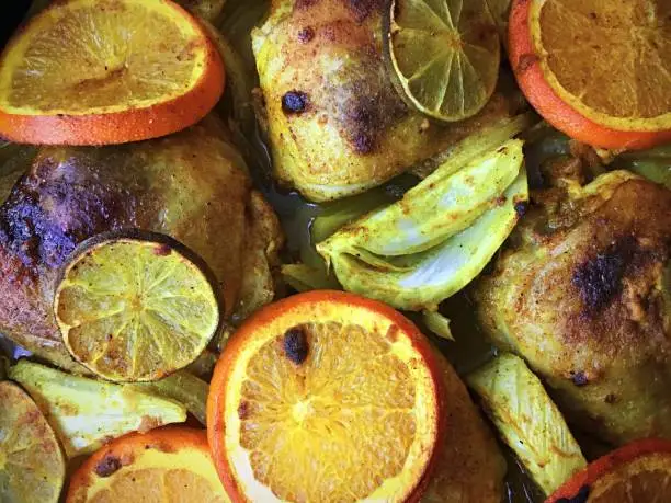 Chicken roasted with sliced oranges, lime, fennel and onions in a turmeric sauce