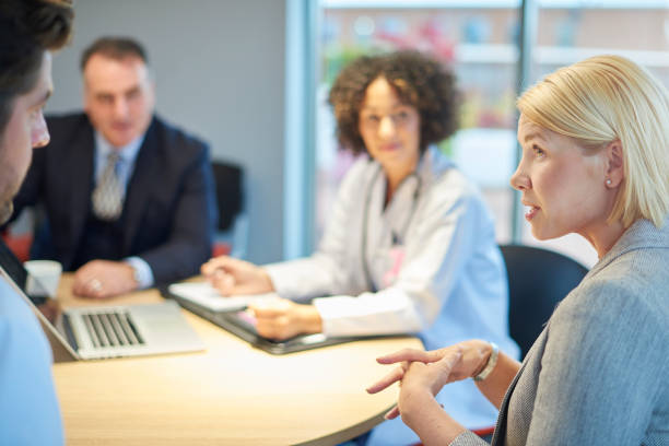 istock salesperson chatting to doctors 872239098