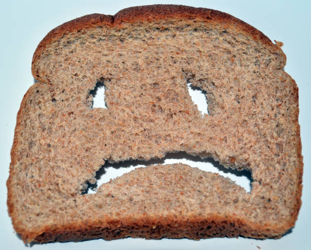istock A slice of bread with a face cut into it. 872243622
