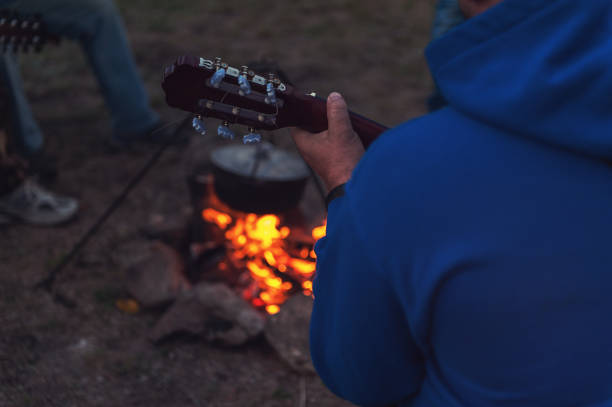istock guitar near the campfire 872243820