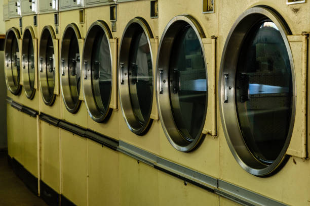 istock Line of dryers in a laundramat 872246784