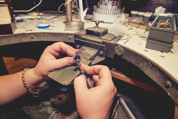 istock Master jeweler produces a gold ring 872250086