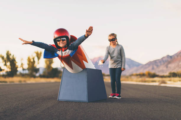 young stunt boy and human cannon ball - teamwork occupation creativity taking off imagens e fotografias de stock