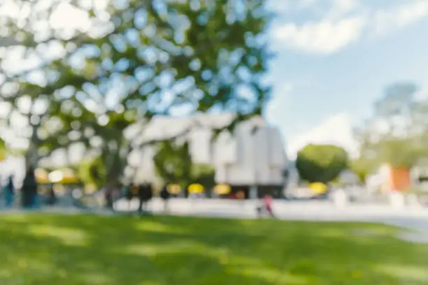 Defocused image of or high school or university campus on sunny autumn day.