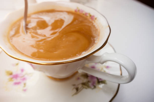 Stirring a Cup of Coffee in Old-fashioned Porcelain