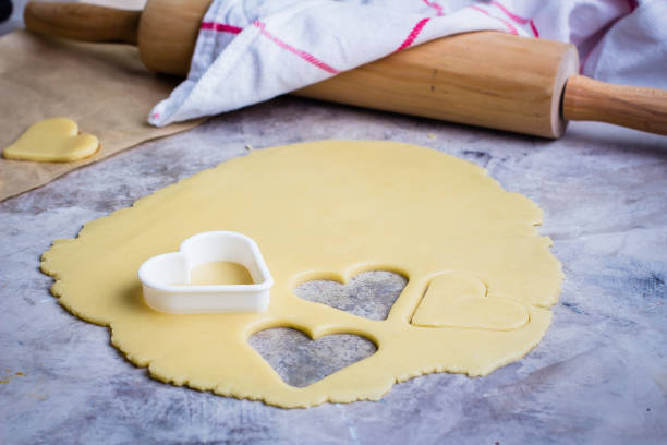 istock Baking love heart cookies for Valentine day. Top view 872270876
