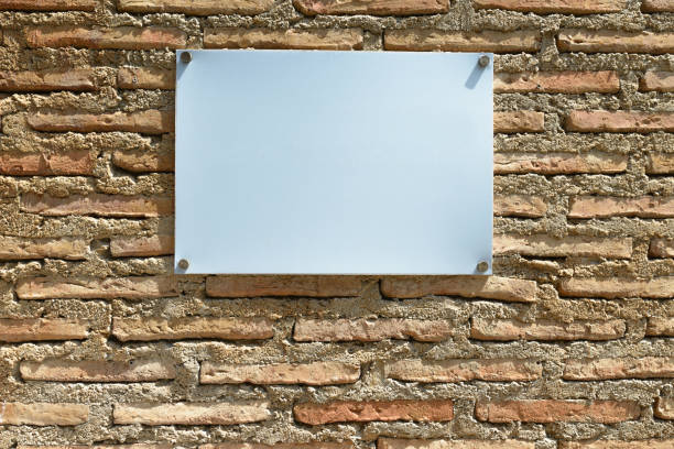 istock Blank White Board With Copy Space Against Brick Wall Outdoors 872274514
